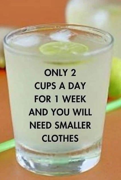A glass of refreshing ginger lemon detox water with a sprinkle of cumin powder on top