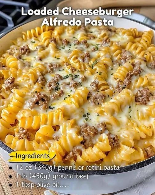 Loaded cheeseburger Alfredo pasta served in a skillet, topped with fresh parsley and extra cheese