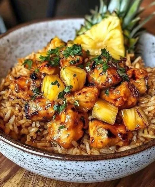 A bowl of sweet and savory pineapple chicken served over fluffy white rice