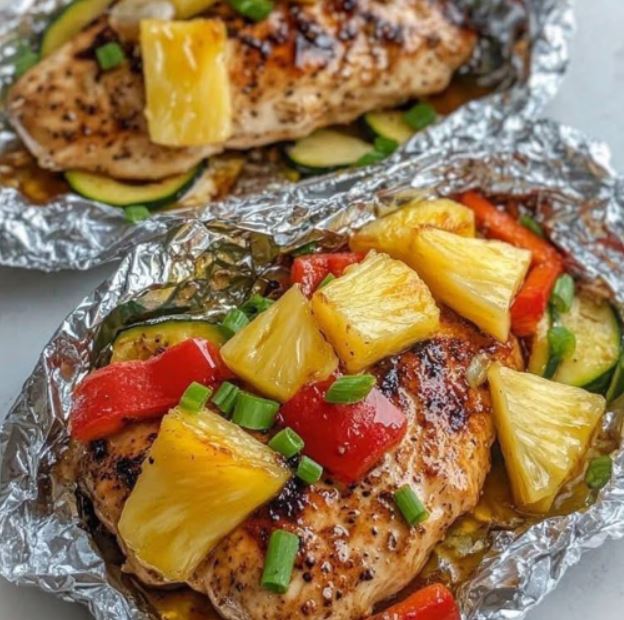"Juicy teriyaki chicken and pineapple foil packets served with rice and garnished with green onions