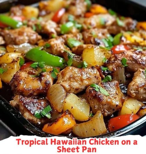 Sheet pan filled with juicy roasted chicken chunks, pineapple, bell peppers, and onions glazed in a tropical marinade